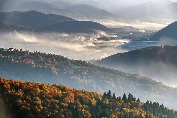 Picturesque autumn landscape with fooggy village in the Carpathian mountains, Ukraine. Landscape photography
