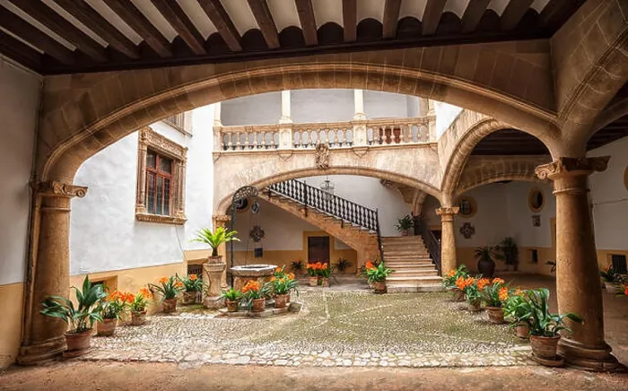 Framed Print : Picturesque mediterranean courtyard with stone pillars and flowers, Palma de Mallorca, Spain Framed Print : Picturesque mediterranean courtyard with stone pillars and flowers, Palma de Mallorca, Spain