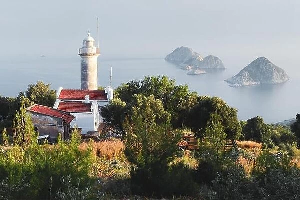 Picturesque scene with lighthouse on Gelidonya cape and small islands in Mediterranean sea. Landscape photography