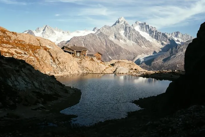 Framed Print : Picturesque view of clear water and mountains reflection on Lac Blanc lake in France Alps. Monte Bianco mountain range on background Framed Print : Picturesque view of clear water and mountains reflection on Lac Blanc lake in France Alps. Monte Bianco mountain range on background