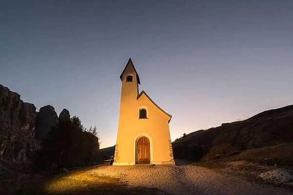 Picturesque view on small iIlluminated chapel - Kapelle Ciapela on Gardena Pass, Italian Dolomites mountains
