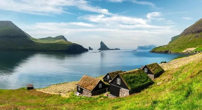 Framed Print : Picturesque view of tradicional faroese grass-covered houses in the village Bour. Drangarnir and Tindholmur sea stacks on background. Vagar island, Fa Framed Print : Picturesque view of tradicional faroese grass-covered houses in the village Bour. Drangarnir and Tindholmur sea stacks on background. Vagar island, Fa