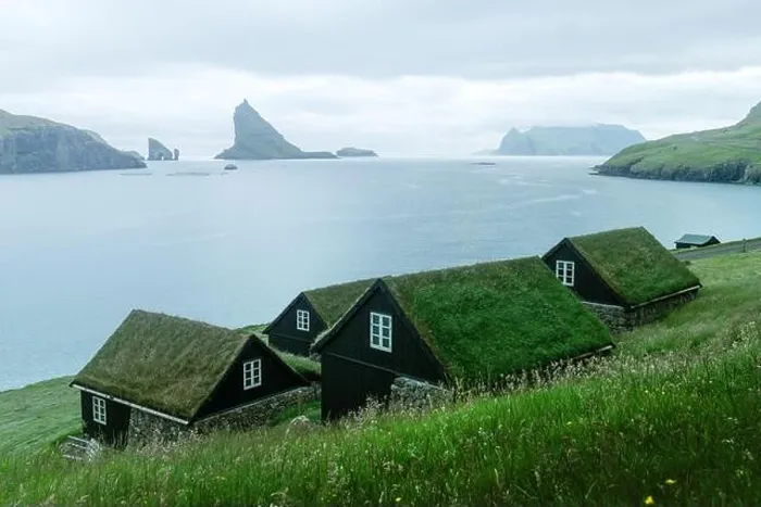 Framed Print : Picturesque view of tradicional faroese grass-covered houses in the village Bour. Drangarnir and Tindholmur sea stacks on background. Vagar island, Fa Framed Print : Picturesque view of tradicional faroese grass-covered houses in the village Bour. Drangarnir and Tindholmur sea stacks on background. Vagar island, Fa