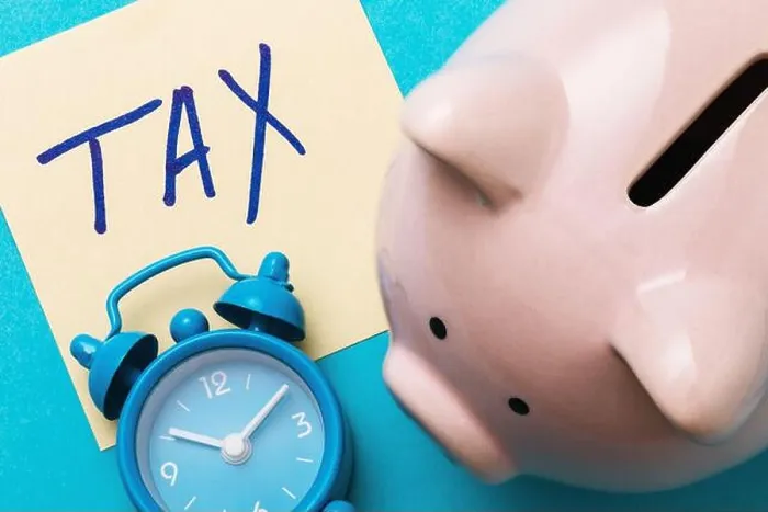 Framed Print : Piggy bank, alarm clock and a sheet of paper with the inscription on a blue background. Tax payment concept Framed Print : Piggy bank, alarm clock and a sheet of paper with the inscription on a blue background. Tax payment concept