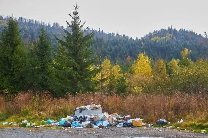 Framed Print : A pile of garbage lies on the background of beautiful mountains Framed Print : A pile of garbage lies on the background of beautiful mountains