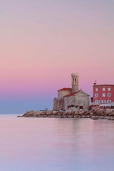 Piran, Slovenia. Cityscape image of Piran, Slovenia with historical church and lighthouse at sunrise
