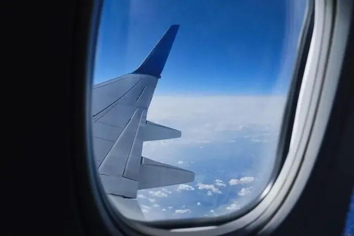 Framed Print : Plane wing in porthole. Aerial sky horizon view from airplane window Framed Print : Plane wing in porthole. Aerial sky horizon view from airplane window