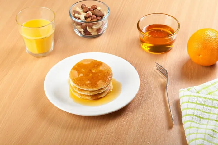 Framed Print : Plate of syrup covered pancakes with a bowl of mixed nuts Framed Print : Plate of syrup covered pancakes with a bowl of mixed nuts
