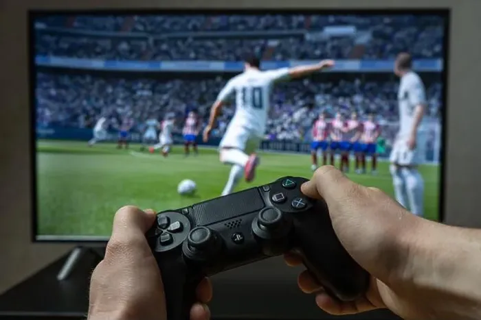 Framed Print : Point of view video gaming. Playing video game on Playstation. Fifa football video game Framed Print : Point of view video gaming. Playing video game on Playstation. Fifa football video game