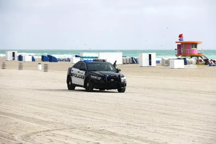 Framed Print : A police car parked at the sandy beach of Miami, Florida, USA Framed Print : A police car parked at the sandy beach of Miami, Florida, USA