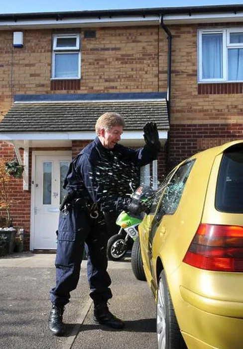 Framed Print : Police officers from the operational team break into a suspects car in Gloucester where one of a series of dawn raids Framed Print : Police officers from the operational team break into a suspects car in Gloucester where one of a series of dawn raids
