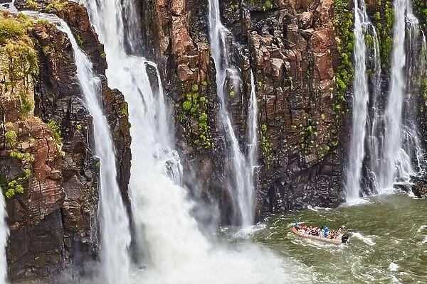 Popular tourist adventure activity at Iguazu Falls, speedboat approaches to water stream, view from Brazilian side