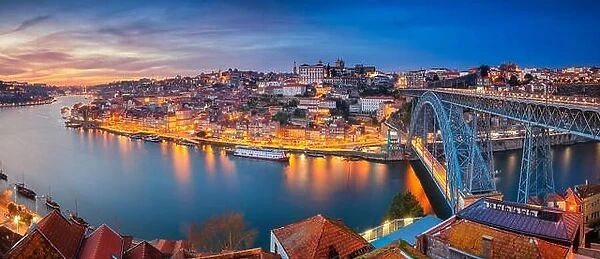 Porto, Portugal. Panoramic cityscape image of Porto, Portugal with the famous Luis I Bridge and the Douro River during dramatic sunset
