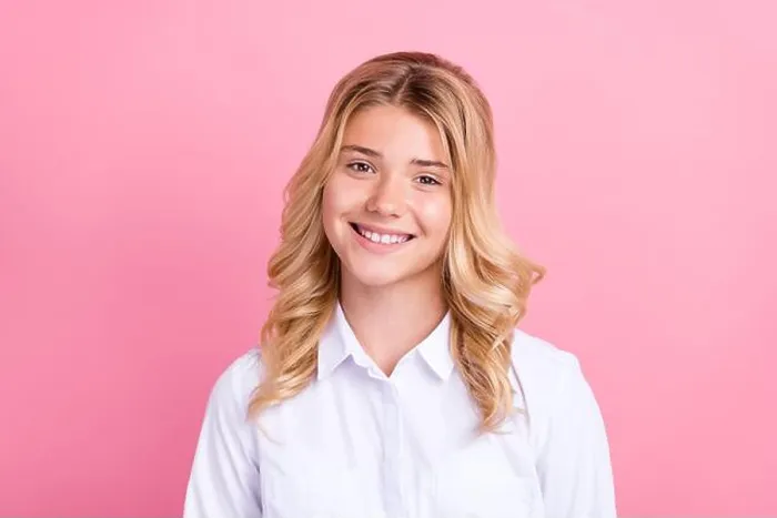 Framed Print : Portrait of attractive cheerful wavy-haired preteen girl wearing white shirt isolated over pink pastel color background Framed Print : Portrait of attractive cheerful wavy-haired preteen girl wearing white shirt isolated over pink pastel color background