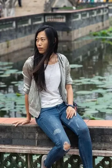 Framed Print : Portrait of beautiful Asian girl hanging out in a Japanese garden pond with some traditional architecture in Framed Print : Portrait of beautiful Asian girl hanging out in a Japanese garden pond with some traditional architecture in