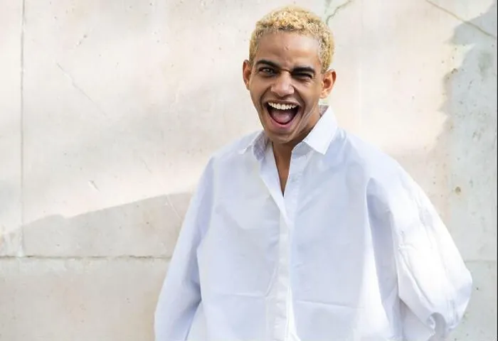 Framed Print : Portrait of beautiful modern young black man with blond hair looking to camera smiling and funny Framed Print : Portrait of beautiful modern young black man with blond hair looking to camera smiling and funny