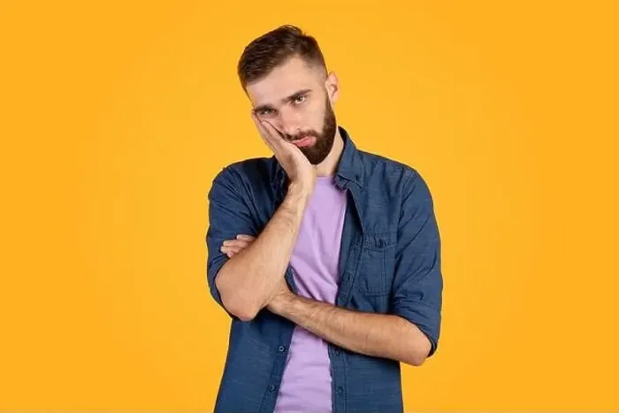 Framed Print : Portrait of bored Caucasian guy leaning on palm and looking at camera on orange studio background Framed Print : Portrait of bored Caucasian guy leaning on palm and looking at camera on orange studio background