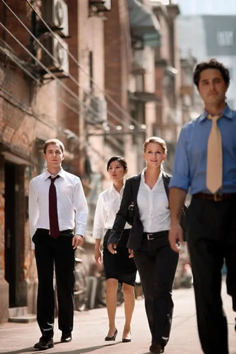 Framed Print : Portrait of four business colleagues walking side by side down a city street Framed Print : Portrait of four business colleagues walking side by side down a city street