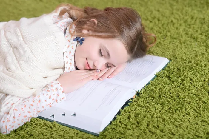Framed Print : Portrait of cute tired schoolgirl sleeping at home Framed Print : Portrait of cute tired schoolgirl sleeping at home