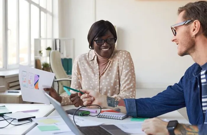 Framed Print : Portrait of two IT developers smiling while designing interface for mobile application or website, copy space