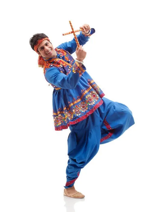 Framed Print : Portrait of happy young man in traditional wear performing Dandiya Rass over white background Framed Print : Portrait of happy young man in traditional wear performing Dandiya Rass over white background