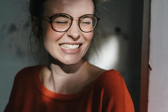 Framed Print : Portrait of happy young woman with glasses Framed Print : Portrait of happy young woman with glasses