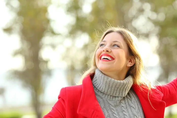 Framed Print : Portrait of a joyful candid girl wearing a red jacket and a sweater joking outdoors in a park in winter Framed Print : Portrait of a joyful candid girl wearing a red jacket and a sweater joking outdoors in a park in winter
