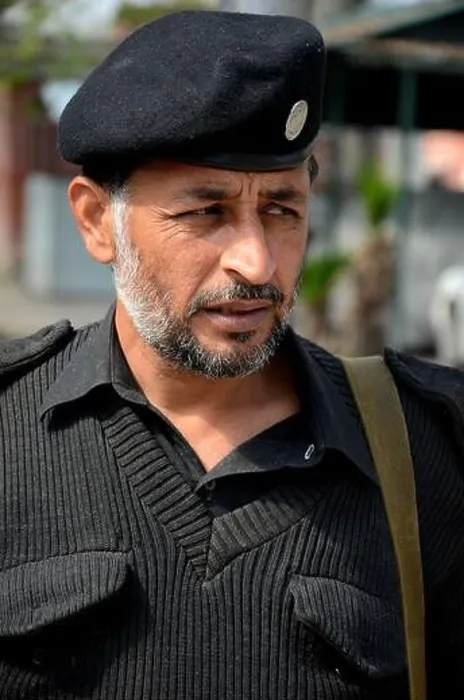 Framed Print : Portrait of Pathan police officer in grey sweater and police hat Peshawar Pakistan