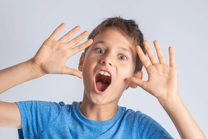Framed Print : Portrait of shocked surprised boy with opening mouth and rised hands looking direct to the camera Framed Print : Portrait of shocked surprised boy with opening mouth and rised hands looking direct to the camera