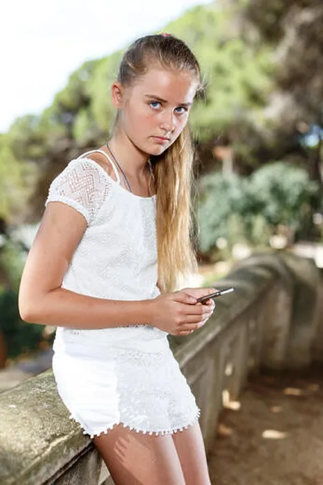 Framed Print : Portrait of teenage cute girl using smartphone at bridge at sunny day outdoor Framed Print : Portrait of teenage cute girl using smartphone at bridge at sunny day outdoor