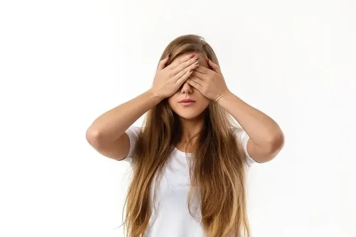 Framed Print : Portrait of young beautiful woman closes her eyes with hand on white background