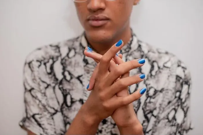 Framed Print : Portrait of young man with blue nail polish Framed Print : Portrait of young man with blue nail polish