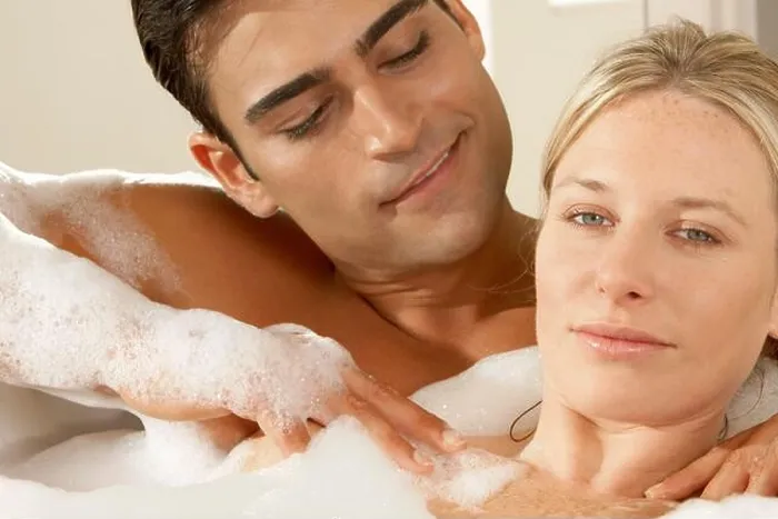 Framed Print : Portrait of a young woman getting a massage from a young man in a bubble bath Framed Print : Portrait of a young woman getting a massage from a young man in a bubble bath