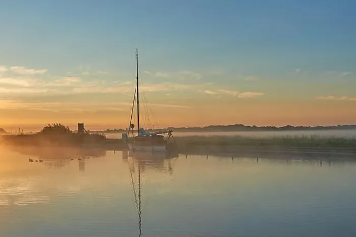 Framed Print : Potter Heigham, Norfolk Broads and a sailing boat moored on the River Thurne during a misty summer sunrise Framed Print : Potter Heigham, Norfolk Broads and a sailing boat moored on the River Thurne during a misty summer sunrise