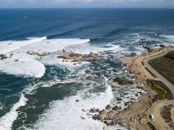 Powerful swells from the Pacific Ocean crash against the rocky coastline of the Monterey peninsula in California