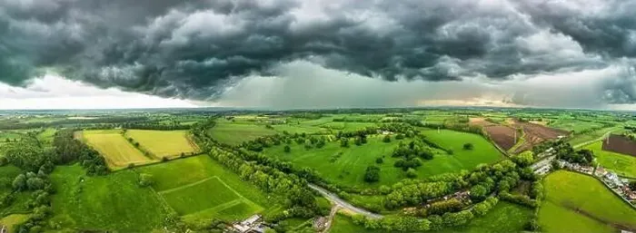 Framed Print : A powerful thunderstorm looms over expansive green fields in North Yorkshire Framed Print : A powerful thunderstorm looms over expansive green fields in North Yorkshire