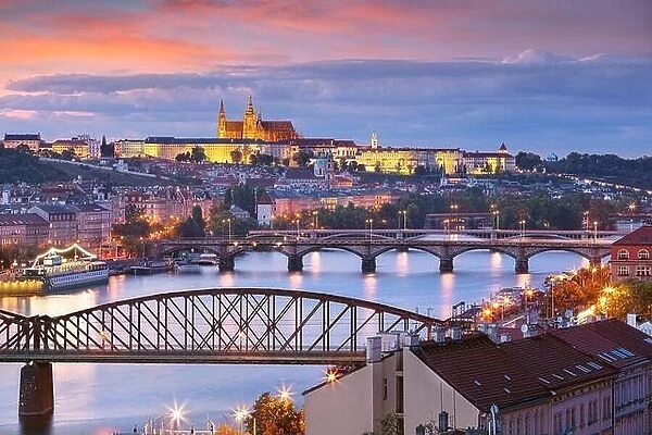 Prague at sunset. Cityscape image of Prague, capital city of Czech Republic with St. Vitus Cathedral and five bridges over Vltava River at autumn suns