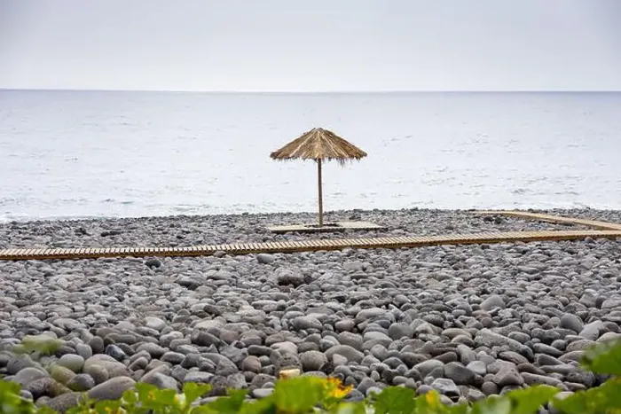 Framed Print : Praia dos Pescadores beach, composed of basalt pebbles and black sand with straw umbrellas and wooden decks Framed Print : Praia dos Pescadores beach, composed of basalt pebbles and black sand with straw umbrellas and wooden decks