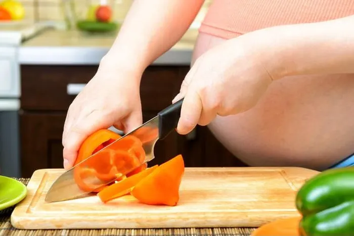 Framed Print : Pregnant woman preparing a healthy meal in the kitchen Framed Print : Pregnant woman preparing a healthy meal in the kitchen
