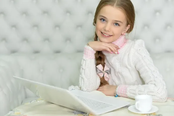Framed Print : Preteen girl with laptop