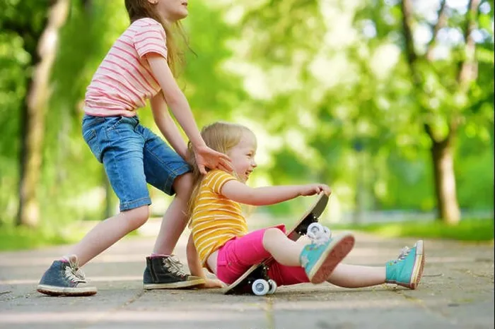 Framed Print : Two pretty little girls learning to skateboard on beautiful summer day in a park. Children enjoying skateboarding ride outdoors Framed Print : Two pretty little girls learning to skateboard on beautiful summer day in a park. Children enjoying skateboarding ride outdoors
