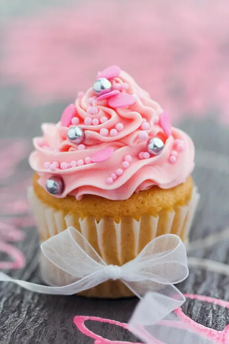 Framed Print : Pretty pink cupcake tied with an organza ribbon Framed Print : Pretty pink cupcake tied with an organza ribbon