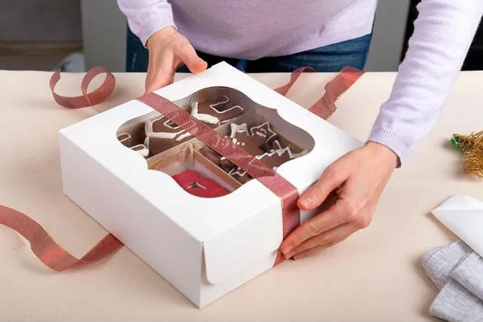 Framed Print : Process of packing confectionery gift box. Cookies in cardboard box Framed Print : Process of packing confectionery gift box. Cookies in cardboard box