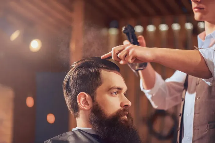 Framed Print : Professional barber styling hair of his client Framed Print : Professional barber styling hair of his client