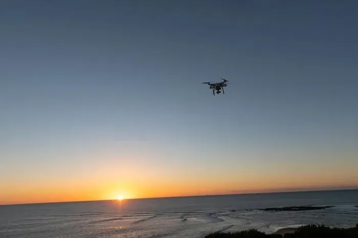 Framed Print : Professional Drone flying at Sunrise over the sea. The sky is glowing Framed Print : Professional Drone flying at Sunrise over the sea. The sky is glowing