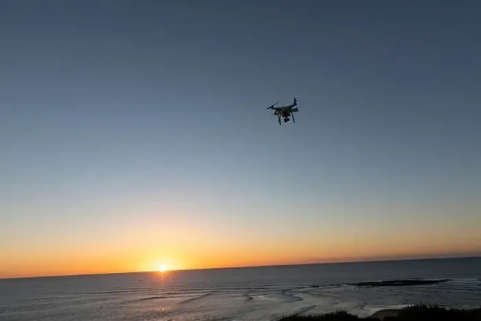 Framed Print : Professional Drone flying at Sunrise over the sea. The sky is glowing Framed Print : Professional Drone flying at Sunrise over the sea. The sky is glowing