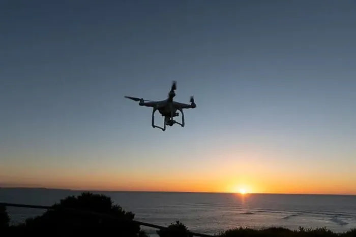 Framed Print : Professional Drone flying at Sunrise over the sea. The sky is glowing Framed Print : Professional Drone flying at Sunrise over the sea. The sky is glowing