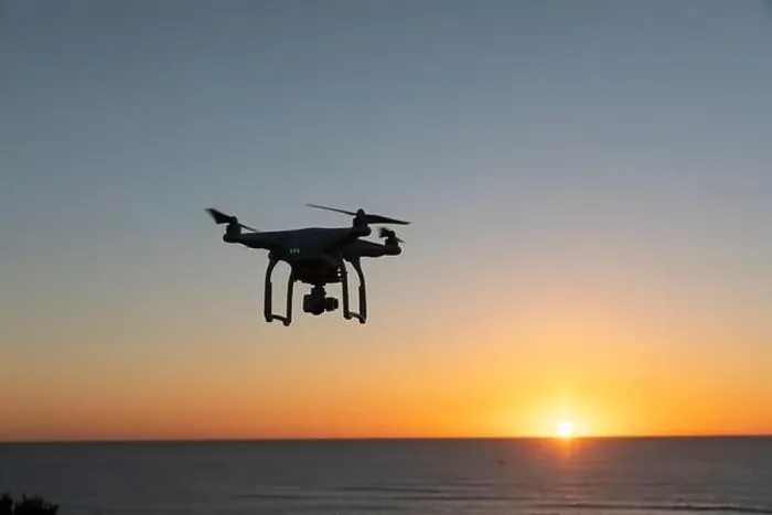 Framed Print : Professional Drone flying at Sunrise over the sea. The sky is glowing Framed Print : Professional Drone flying at Sunrise over the sea. The sky is glowing