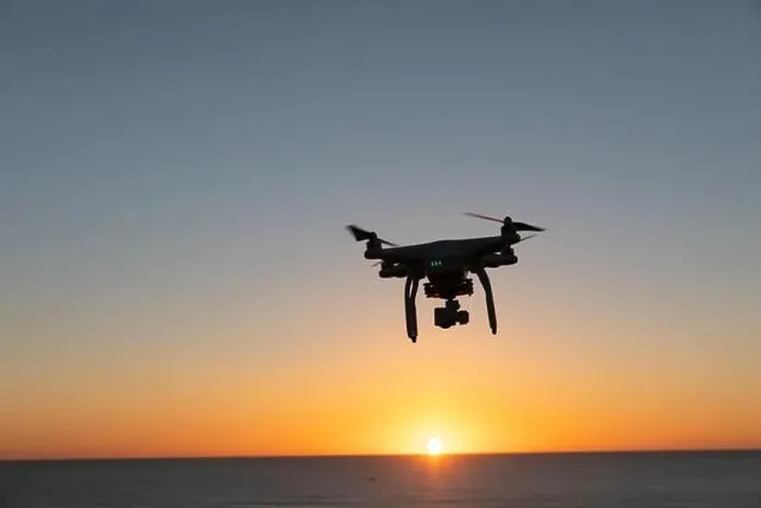 Framed Print : Professional Drone flying at Sunrise over the sea. The sky is glowing Framed Print : Professional Drone flying at Sunrise over the sea. The sky is glowing