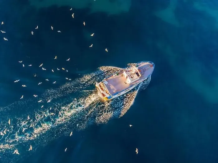 Framed Print : professional fisherboat with many seagulls come back in the harbor. Aerial view, drone Framed Print : professional fisherboat with many seagulls come back in the harbor. Aerial view, drone